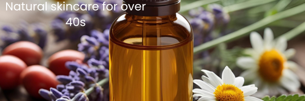 amber glass bottle of liquid surrounded by rosehips, chamomile flowers and lavender