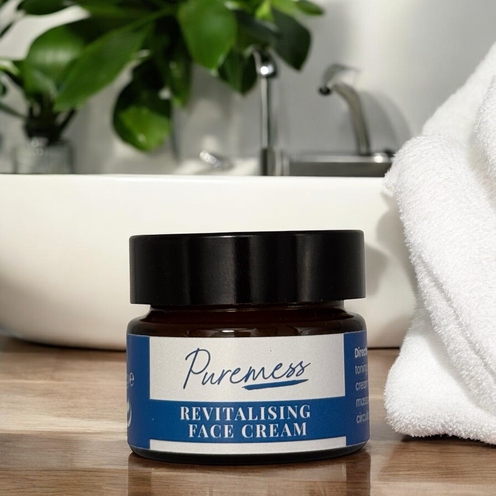 Amber glass container with black lid labeled Puremess Revitalising Face Cream, emphasizing natural skincare and sustainable. - Men's Revitalising Face Cream - PUREMESS SKINCARE