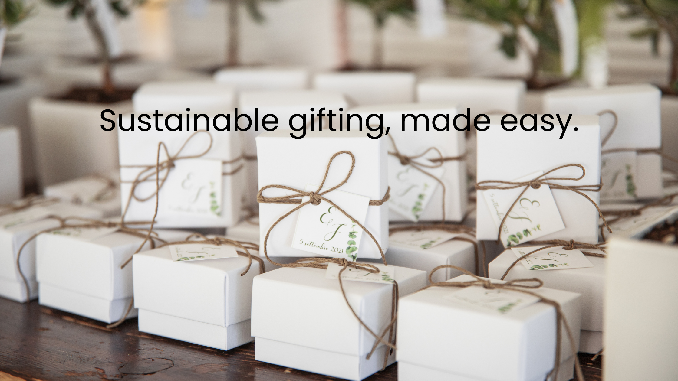several little white boxes tied with twine on a table