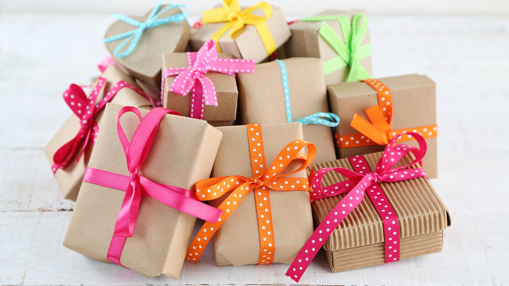 Several small packages wrapped in brown paper and colourful ribbons