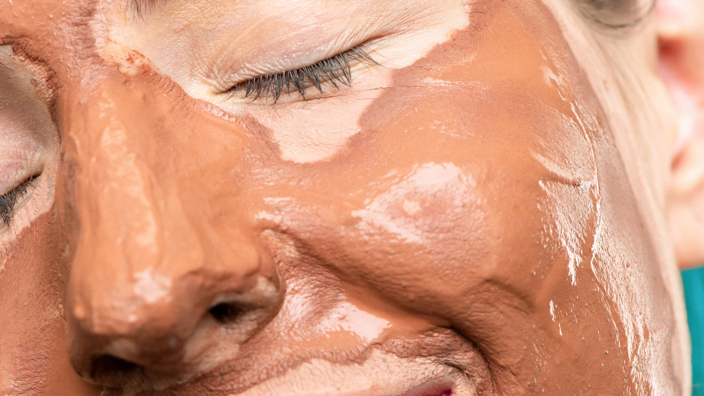 Woman with rose clay face mask on her skin