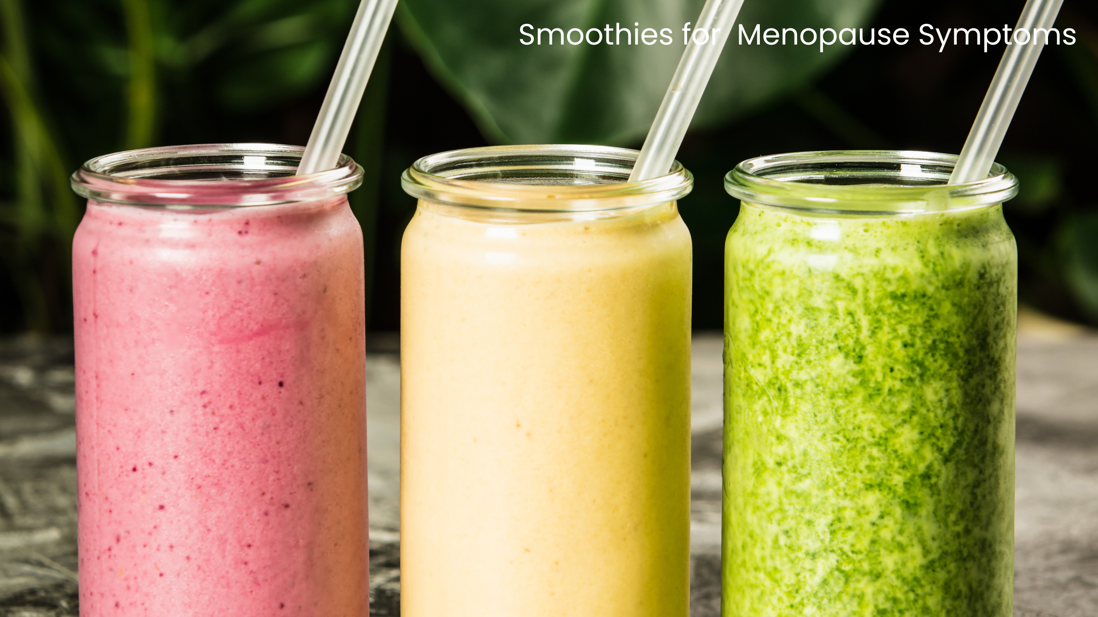 three glass jars containing smoothies, one is pink, one is yellow and one is green.  All have a straw