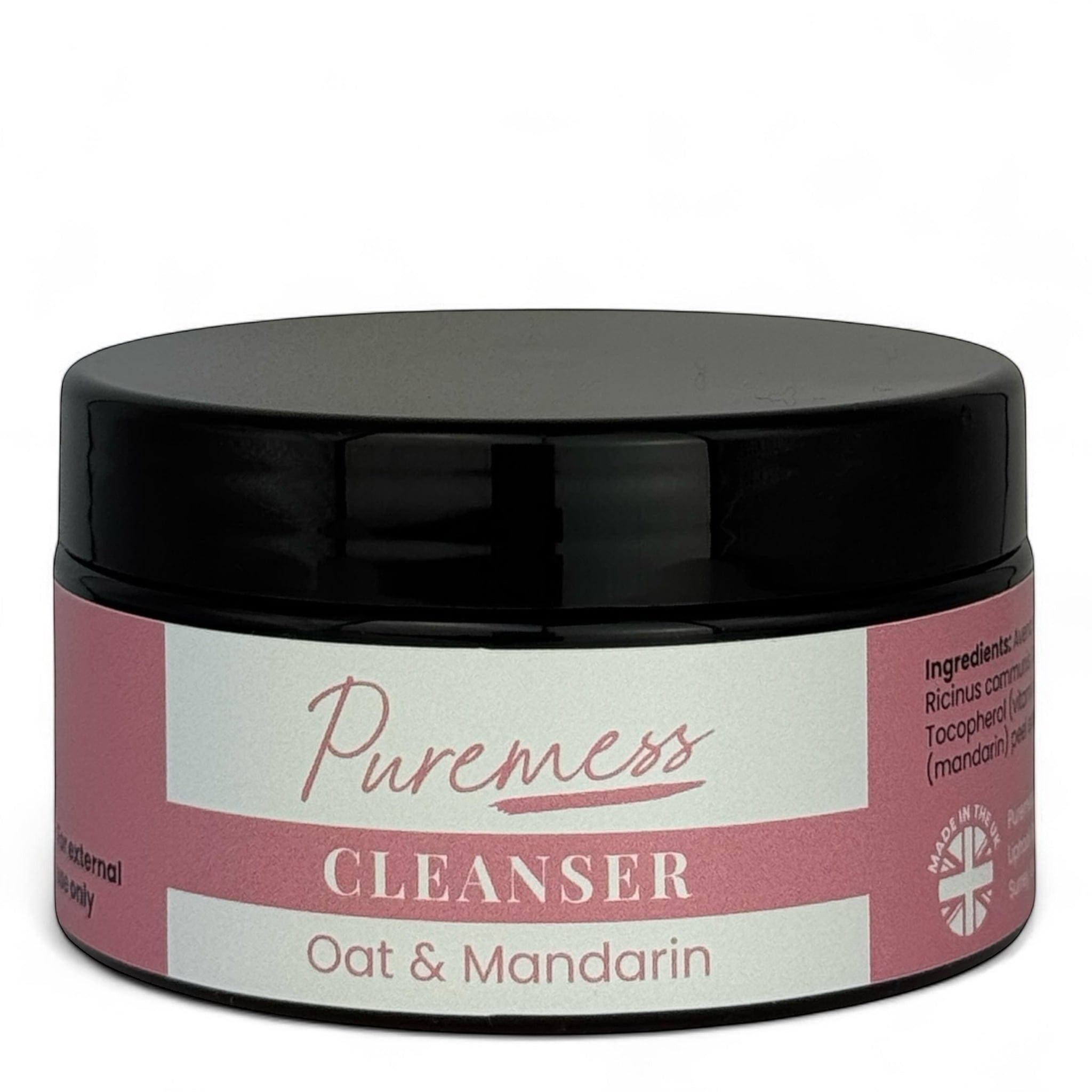 Round pink jar with black lid labeled Puremess cleanser, oat & mandarin scent, eco-friendly skincare packaging. - Oat & Mandarin Cleanser