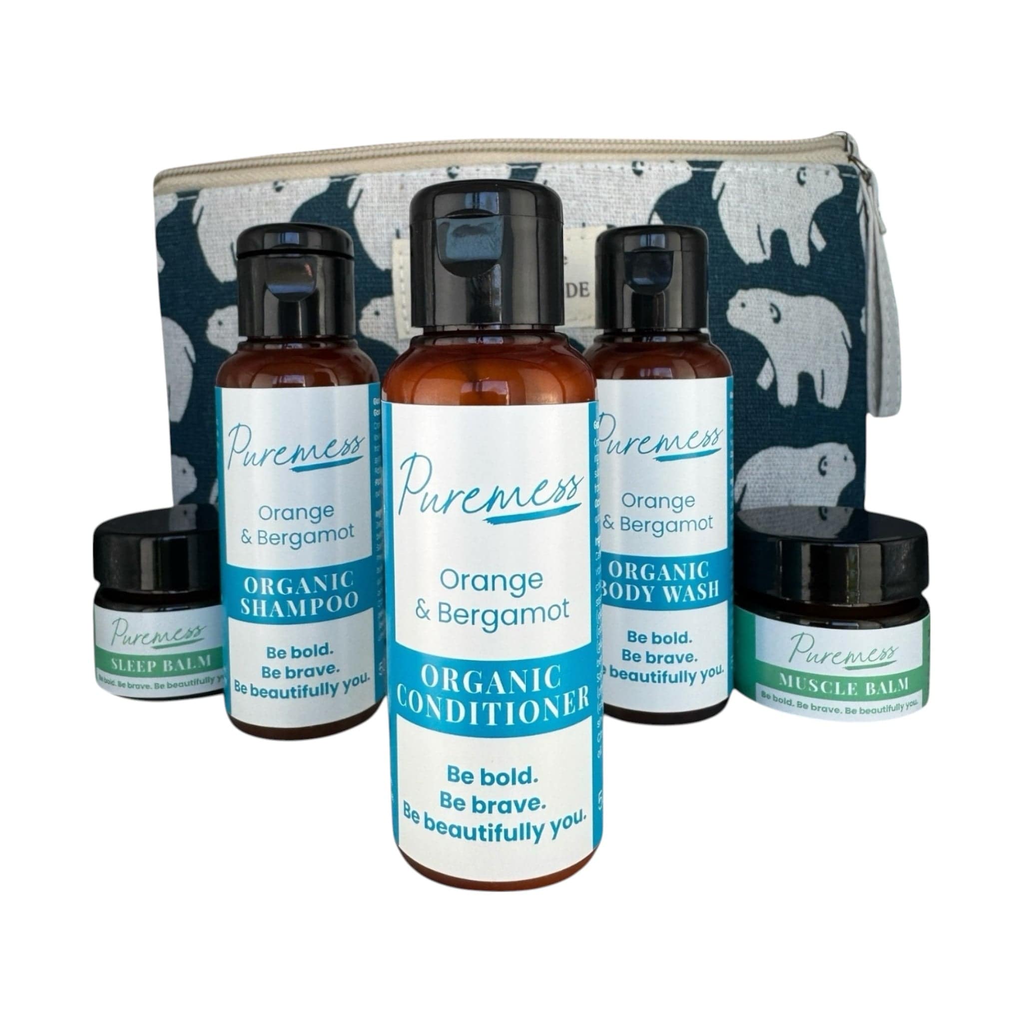 Amber brown travel bottles with black caps labeled "Orange & Bergamot" organic shampoo, conditioner, and body wash alongside - Orange & Bergamot Travel Set | Hair, Body & Wellness Essentials in a Handmade Bag