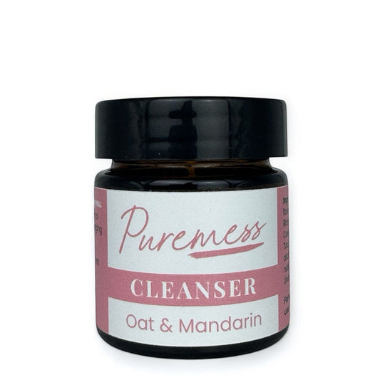 Dark amber container with black lid labeled Puremess Oat & Mandarin Cleanser featuring natural skincare, botanical. - Oat Mandarin Cleanser - PUREMESS SKINCARE