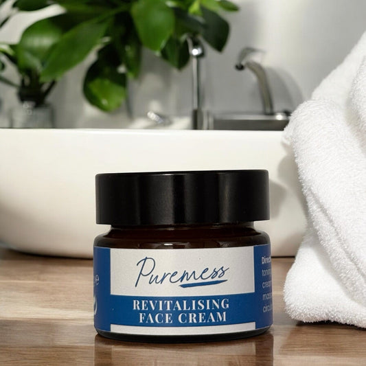 Amber glass container with black lid labeled Puremess Revitalising Face Cream, emphasizing natural skincare and sustainable. - Men's Revitalising Face Cream - PUREMESS SKINCARE