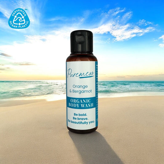 Amber container with black cap holding Puremess Orange & Bergamot organic body wash, eco-friendly beauty with botanical. - Orange & Bergamot Body Wash - PUREMESS SKINCARE